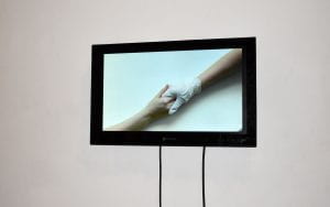 Image of two hands on screen