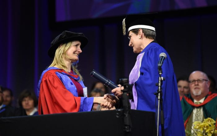 Children's Laureate Cressida Cowell shakes the hand of Vice Chancellor Professor Debra Humphries at the degree ceremony.