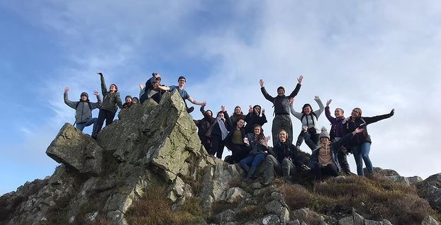 Group of students on top of a rock