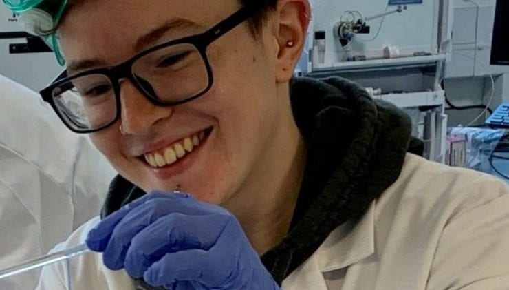 Close up of student working in the lab and smiling