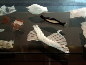 Items of fabric in a glass display case