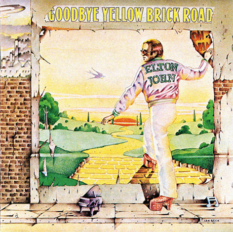 Album cover of Elton John in platform shoes and name on jacket stepping through a wall onto a yellow brick road