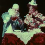 Early colour film still of two clowns against a dark background, filmed in 1906.