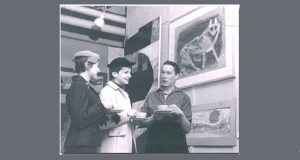 Greyscale photograph of Juliet Kepes and colleagues in a gallery.