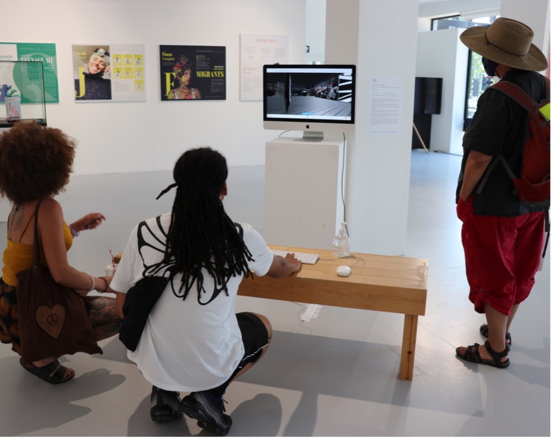 gallery visitors looking at an exhibition display screen