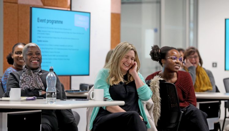 Guests laughing at a Women in Leadership event