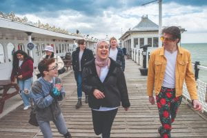 Group of students laughing on Brighton Palace Pier