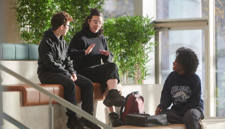 students sitting chatting in Elm House atrium