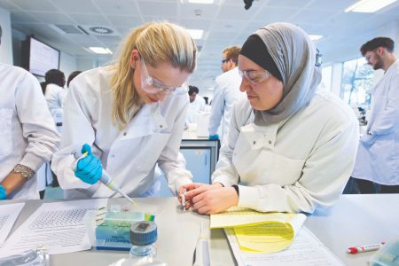 Two female students working in the cell pathology lab