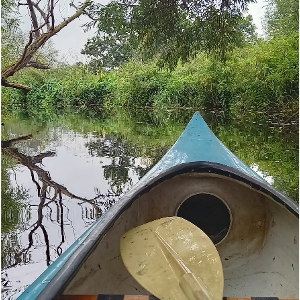 view of front of kayak going down a river