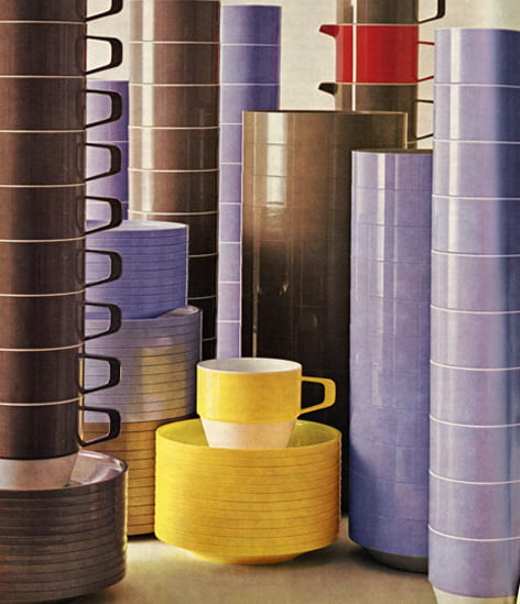 A colour image of colourful plastic cups and saucers piled up high