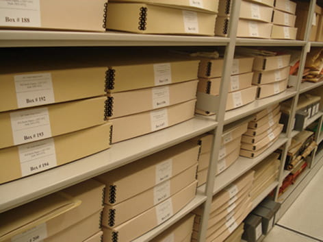 A general colour photograph of archival boxes stored at the Archive of the Chartered Society of Designers. Taken by Leah Armstrong.