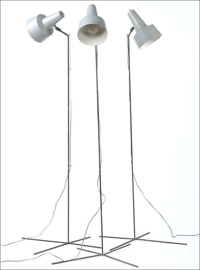 A colour photograph of three floor lamps with grey reflectors. Designed by Bernard Schottlander in the 1950s. Taken from the Bernard Schottlander Archive housed at the University of Brighton Design Archives.