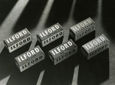 Black and white photograph showing 6 boxes of Ilford film, 2 each of FP3, HP3 and Selochrome.