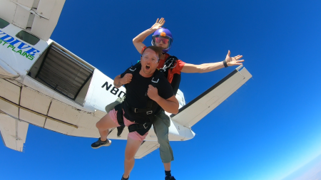 Two people jumping out of plane