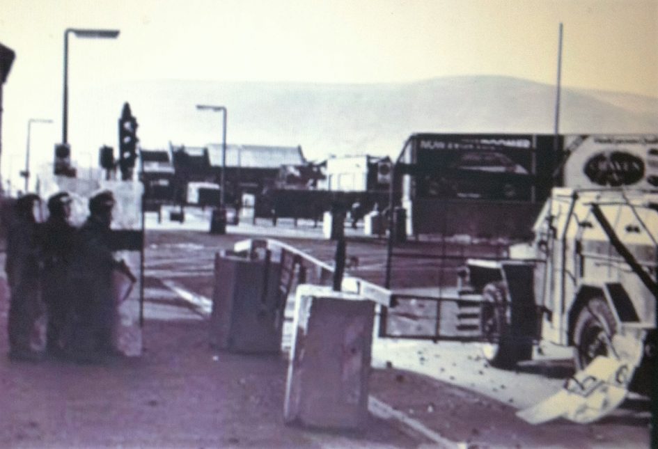 Image of Northern Ireland Troubles. Soldiers in riot gear at a roadside next to an armoured vehicle