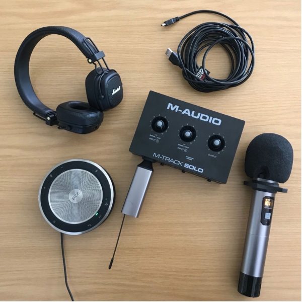 A photo of some audio equipment and microphone on a table top