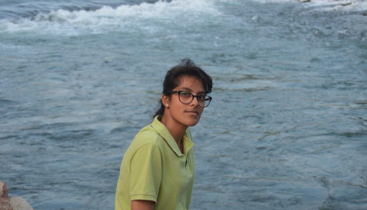Student Zahin in front of the sea
