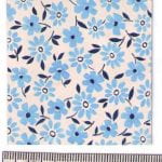 Fabric design with blue flowers closely grouped and speckled leaves from the Walter Fielden Royle collection