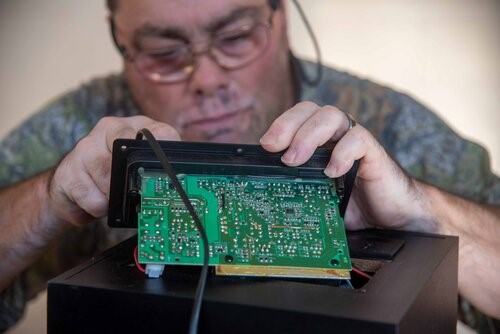 man fixing circuit board