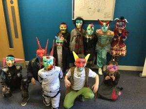 Children wearing the facemasks they made at the university