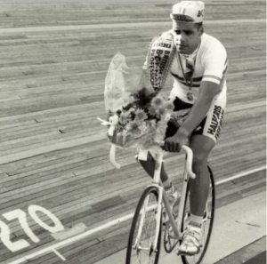 Cyclist Russell Williams cucling on the track with a bouquet of flowers