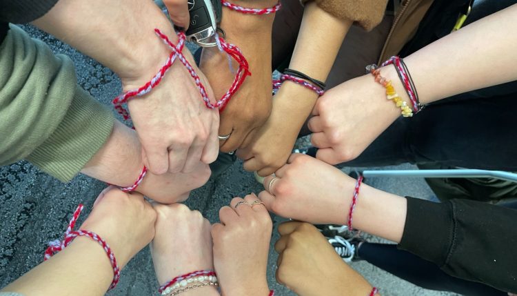 group shot of everyone's hands together in circle