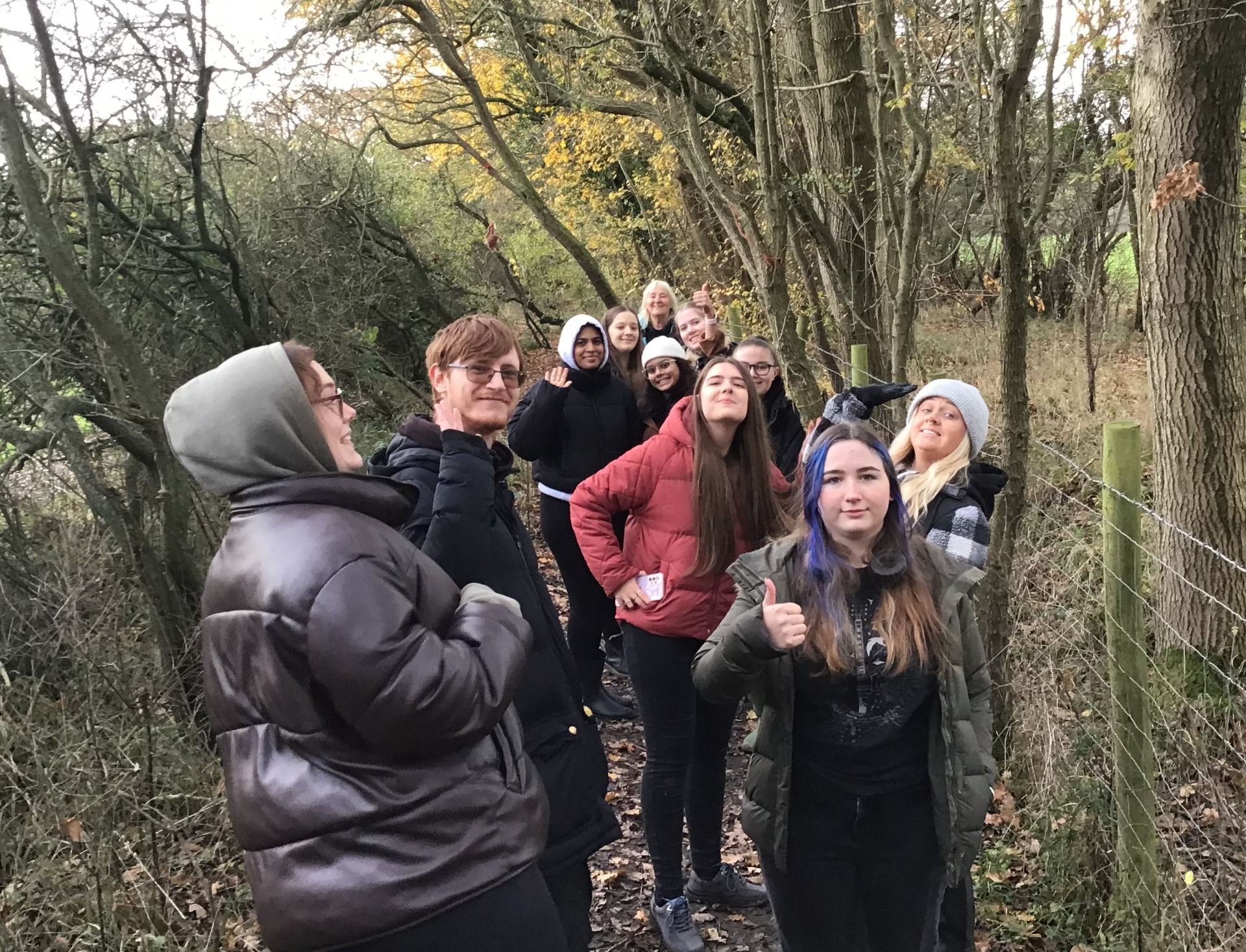 group photo of students in woods at forest school