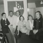 Group of six people gathered in front of an IFI banner