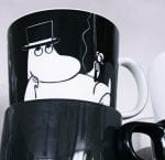 A Moomin mug stacked together with three plain mugs