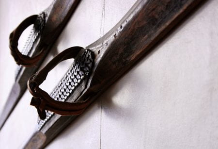 A pair of old wooden skis hanging on a wall