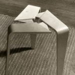 Two interlockable three-legged wooden stools