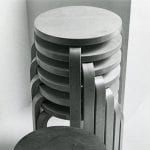 Six stackable three-legged stools