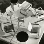 Multiple wood-framed stools and easy chairs designed by Alvar Aalto
