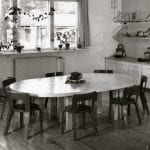 A black and white photo of nursery furniture setting with table and chairs