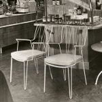 Black and white photo of showcase chairs and table in a grocery store setting