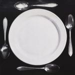 Black and white poster showing a plate with four spoons around it