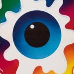 A poster depicting an eyeball shape in the middle of splashes of colour