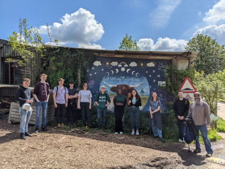 Students and lecturers at the farm entrance