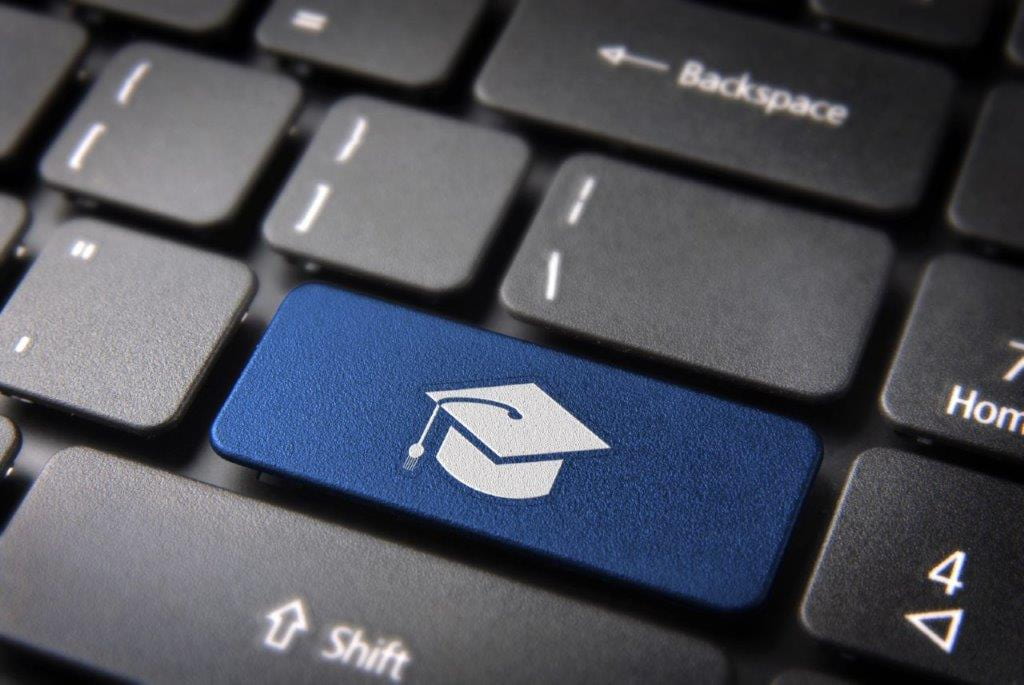 Blue keyboard button with the symbol of a graduation hat