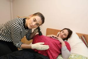 a student examining a patient