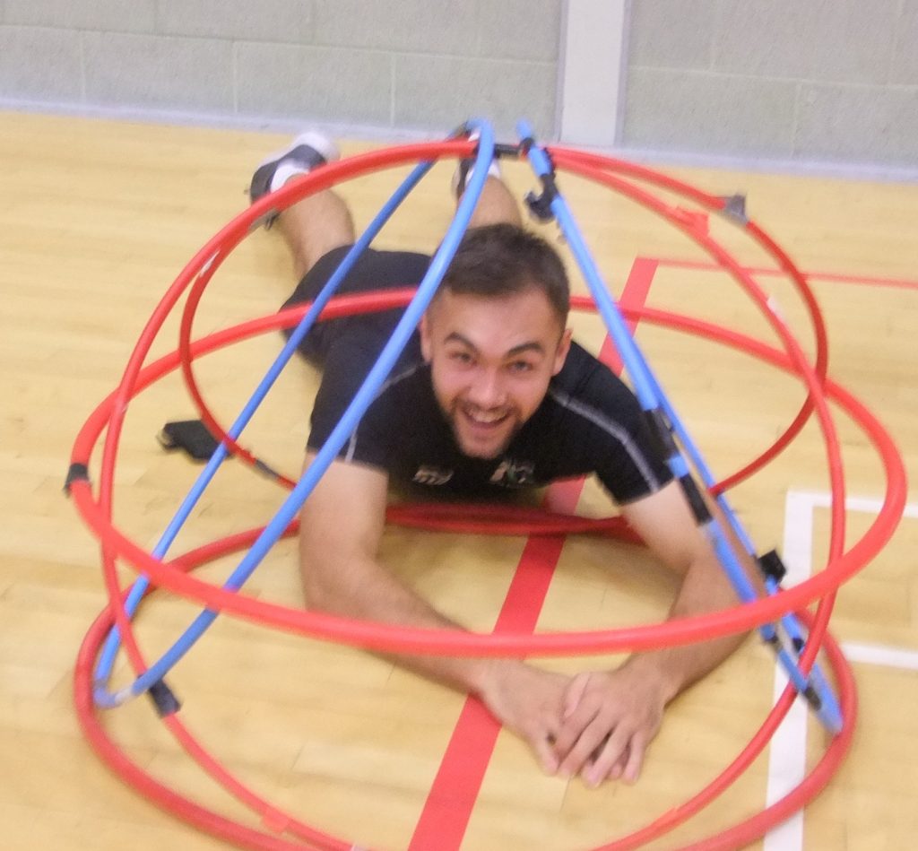 a student under a pile of hoops