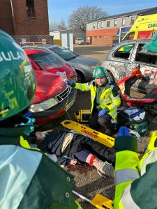 student paramedics between damaged cars