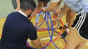 students making shapes with hula hoops