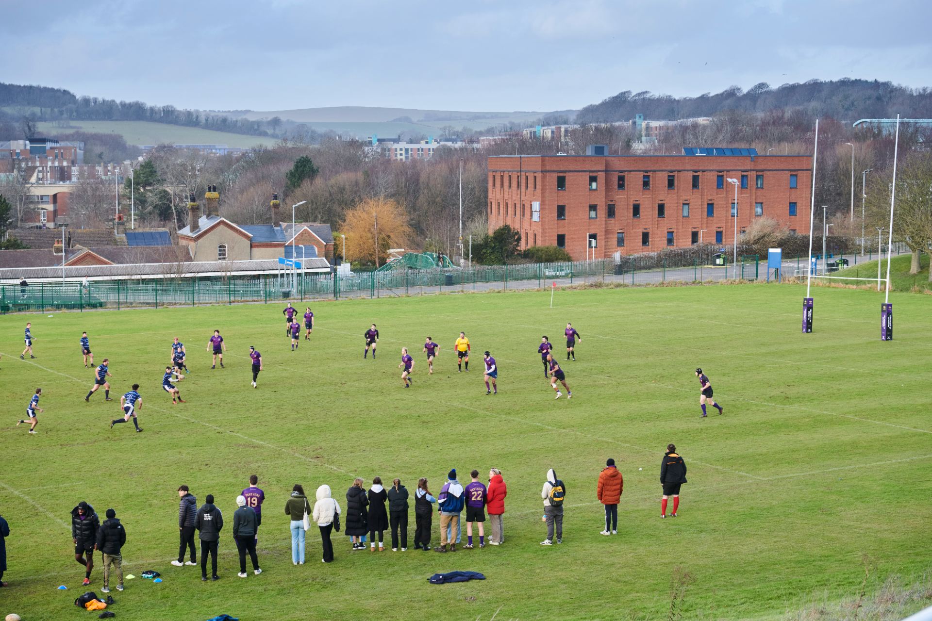 students playing rugby on one of the outside pitches