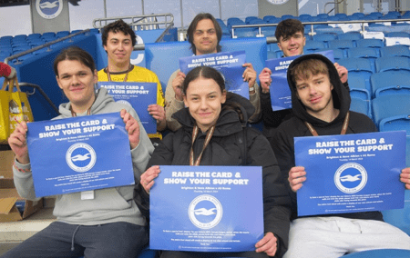 students at the Amex holding cards