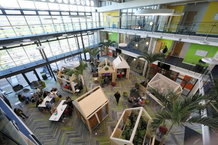Image shows high view of wooden structures where students can work in the atrium of Checkland