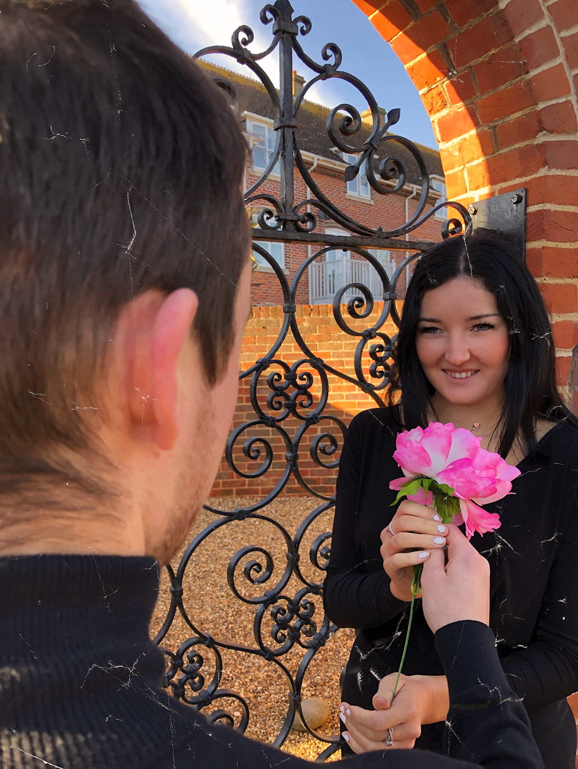 Person receiving pink flowers