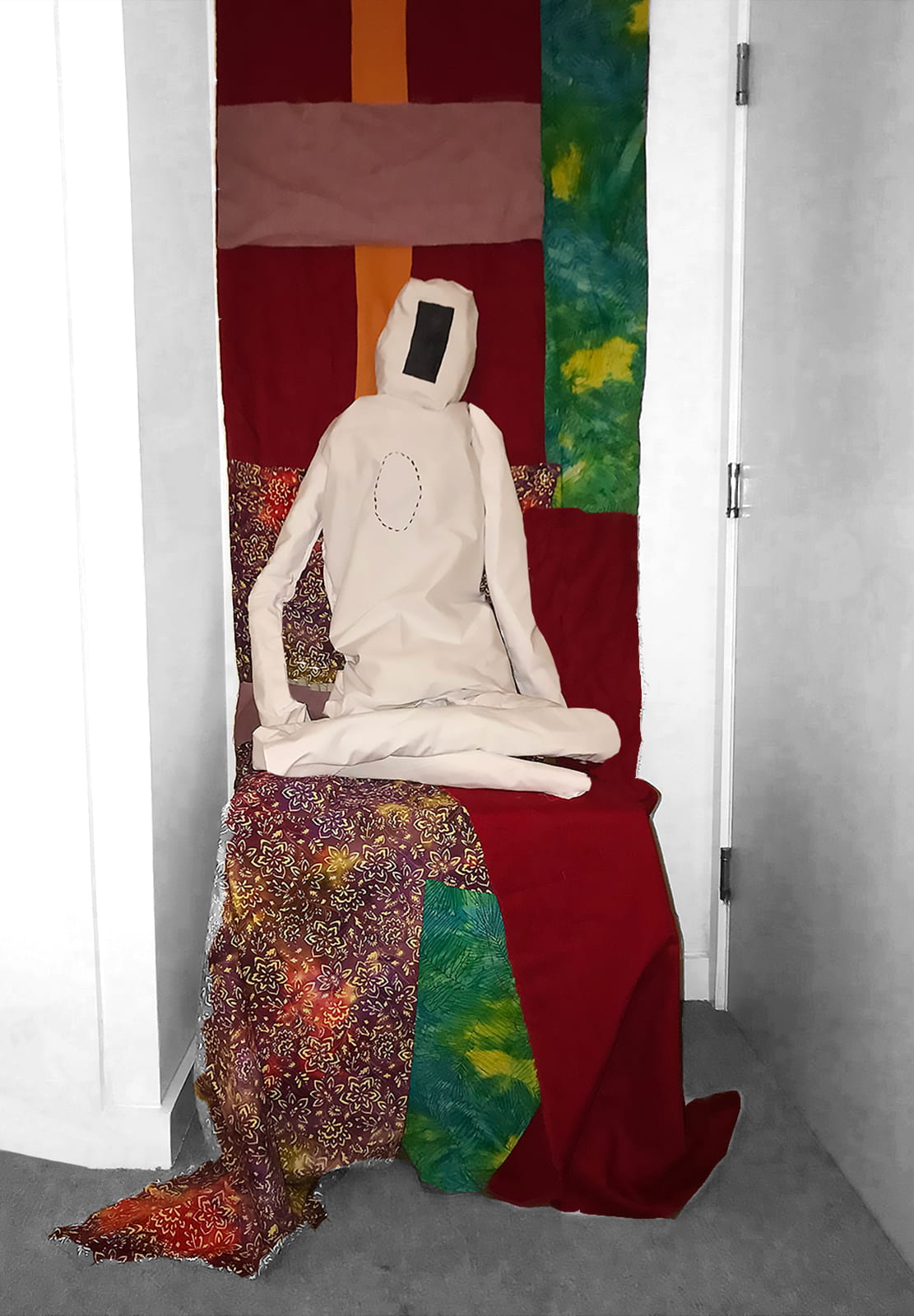 abstract figure made of cloth on a colourful fabric