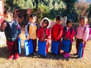 a group of children with their school bags